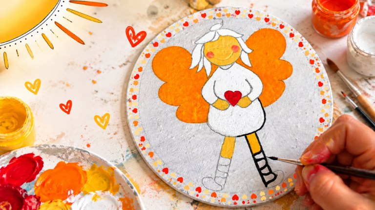 Schutzengel malen mit Kindern – ein Engel mit orangefarbenen Flügeln und rotem Herz wird mit einem feinen Pinsel gestaltet